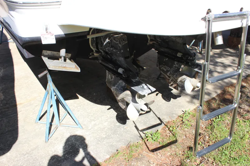 Slide: The Image of 2005 Sea Ray 290 Sundeck boat with dual propellers and ladder, on stands. - 7