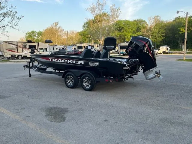 Slide: The Image of 2025 Tracker Savage 215 boat parked under a bridge, showcasing sleek design and modern features. - 2