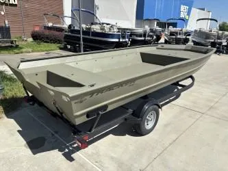 Slide: The Image of 2025 Tracker Grizzly 2072 Utility boat on trailer, parked on grassy area. - 2