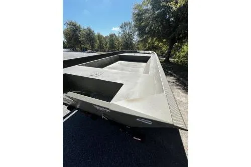 Slide: The Image of 2025 Tracker Grizzly 2072 Utility boat, parked outdoors on a sunny day. - 2