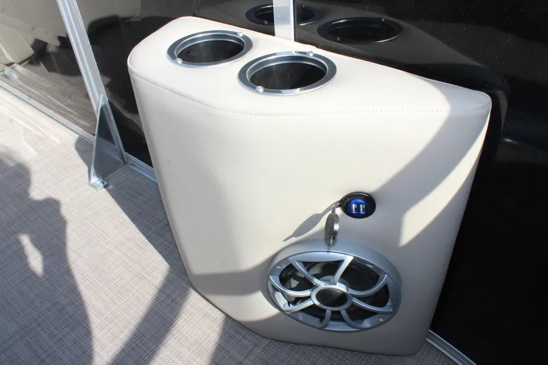 Slide: The Image of Cup holders and speaker on 2025 Sun Tracker SportFish 20 DLX boat interior. - 11