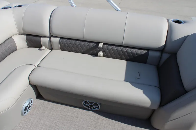 Slide: The Image of 2025 Sun Tracker SportFish 20 DLX boat interior with beige cushioned seating and speaker. - 13