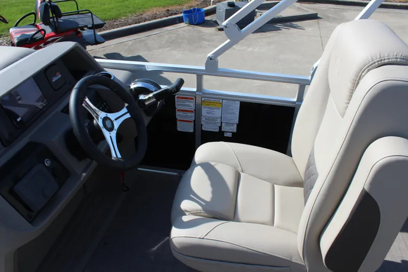 Slide: The Image of 2025 Sun Tracker SportFish 20 DLX boat interior with steering wheel and captain's chair. - 15