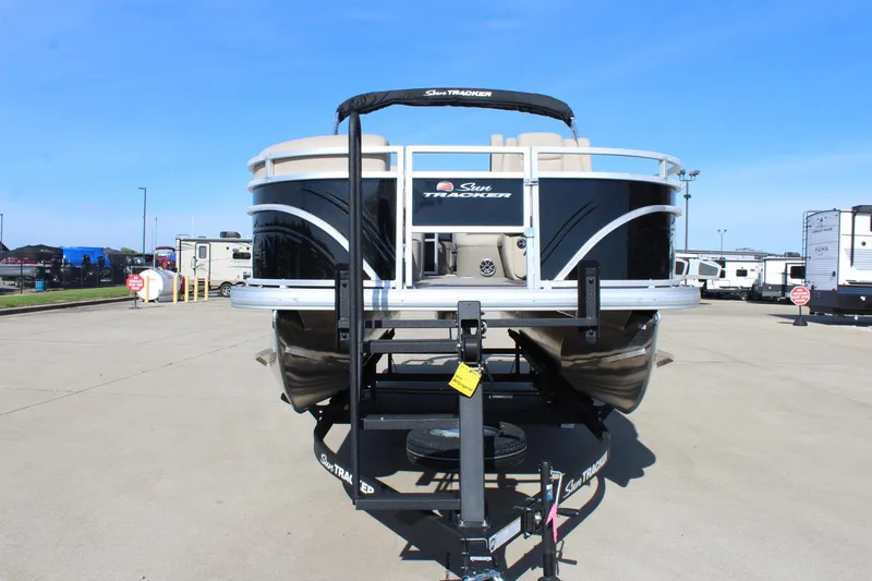 Slide: The Image of 2025 Sun Tracker SportFish 20 DLX pontoon boat on trailer in parking lot. - 2
