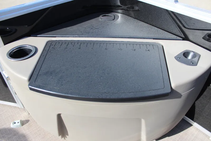 Slide: The Image of 2025 Sun Tracker SportFish 20 DLX boat console with cup holders and measuring board. - 21