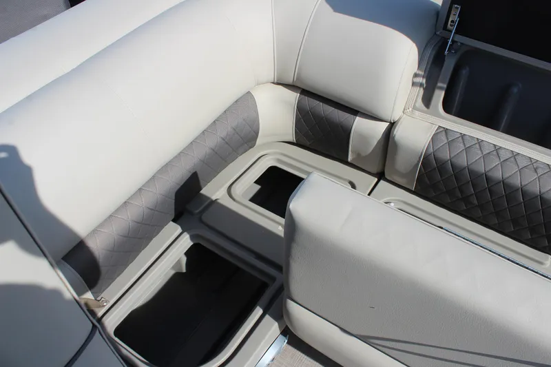 Slide: The Image of 2025 Sun Tracker SportFish 20 DLX boat seating with storage compartments, featuring gray and white upholstery. - 26