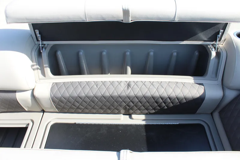 Slide: The Image of 2025 Sun Tracker SportFish 20 DLX boat storage compartment with quilted upholstery. - 27