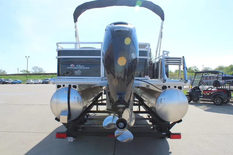 Slide: The Image of 2025 Sun Tracker SportFish 20 DLX pontoon boat, rear view with motor and trailer. - 6