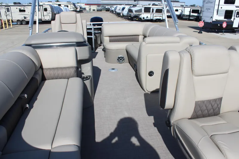 Slide: The Image of 2025 Sun Tracker SportFish 20 DLX pontoon boat interior with beige seating and spacious layout. - 8