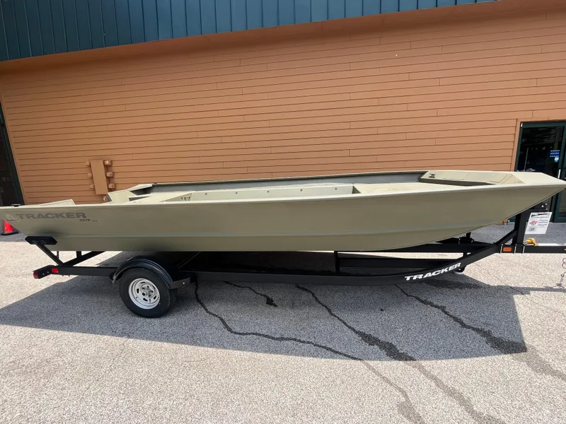 The Image of 2025 Tracker GRIZZLY 2072 Utility boat on trailer, parked outdoors. - 0