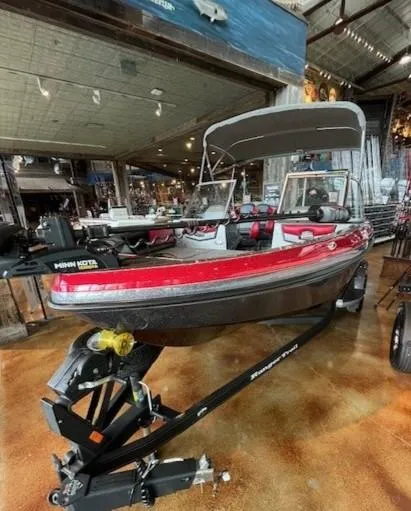 Slide: The Image of 2024 Ranger 1850MS boat with red and black design on display in a showroom. - 2