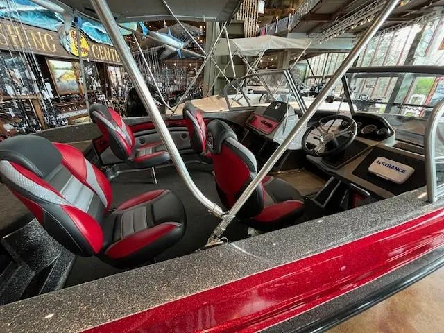 Slide: The Image of 2024 Ranger 1850MS boat interior with red and black seats, steering wheel, and Lowrance display. - 3