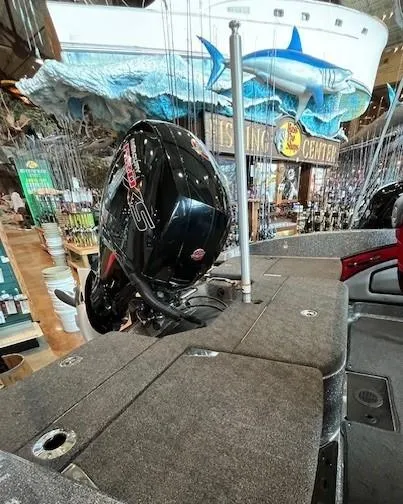 Slide: The Image of 2024 Ranger 1850MS boat with motor, displayed indoors near fishing center decor. - 4