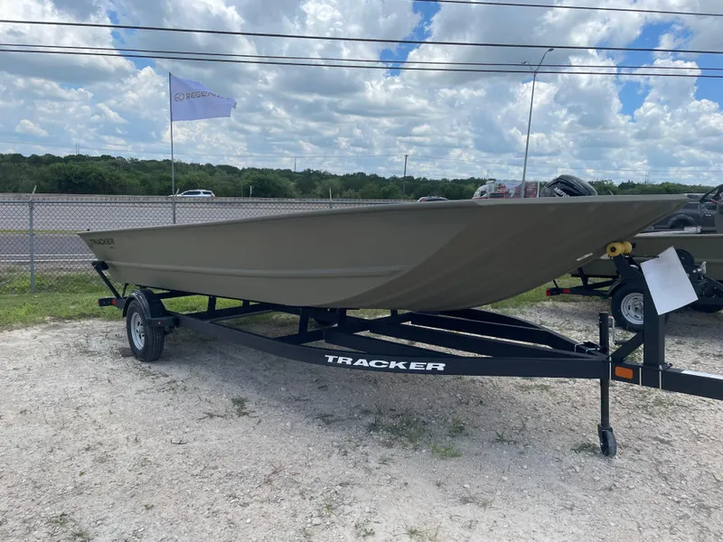 The Image of 2025 Tracker GRIZZLY 2072 Utility boat on trailer, parked outdoors under cloudy sky. - 0