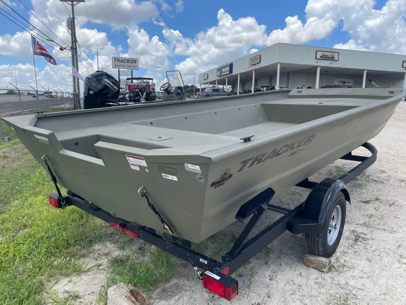 Slide: The Image of 2025 Tracker GRIZZLY 2072 Utility boat on trailer at dealership, under blue sky. - 6