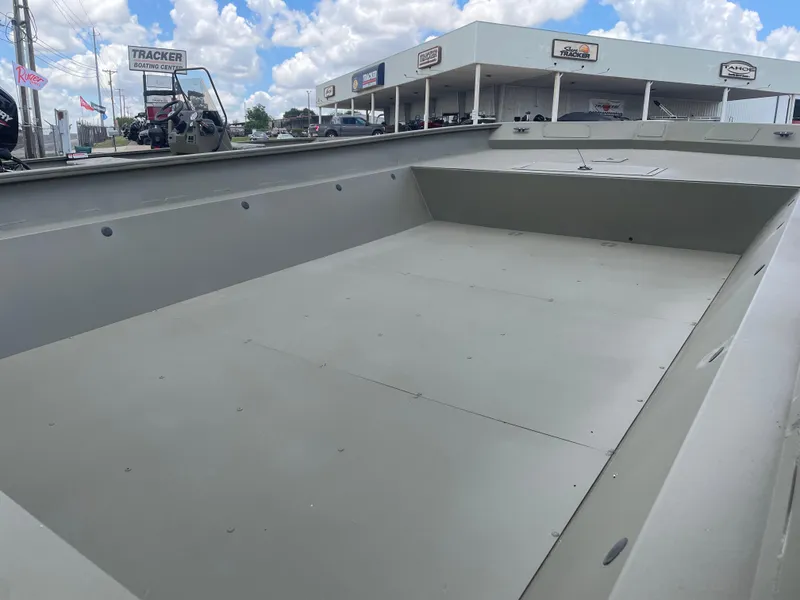 Slide: The Image of 2025 Tracker GRIZZLY 2072 Utility boat at dealership, under a partly cloudy sky. - 8