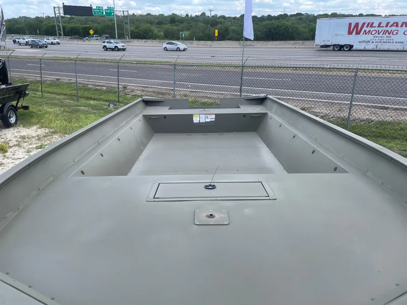 Slide: The Image of 2025 Tracker GRIZZLY 2072 Utility boat on display near highway. - 9