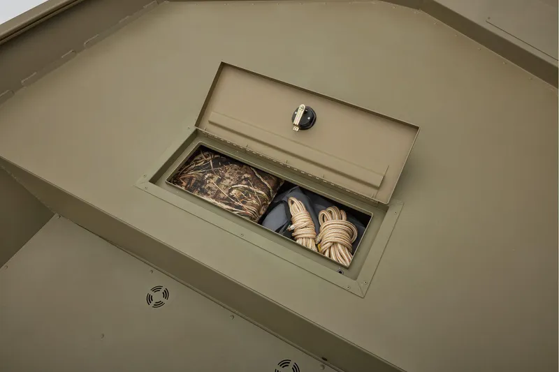 Slide: The Image of Storage compartment in 2025 Tracker GRIZZLY 2072 Utility boat with rope and camouflage gear. - 7