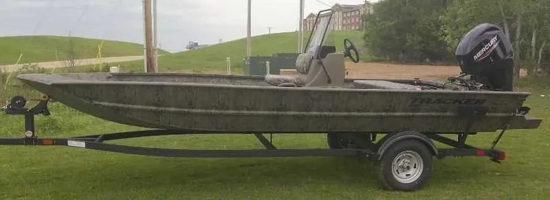 Slide: The Image of 2025 Tracker Grizzly 1860 CC boat on trailer, parked on grass. - 2
