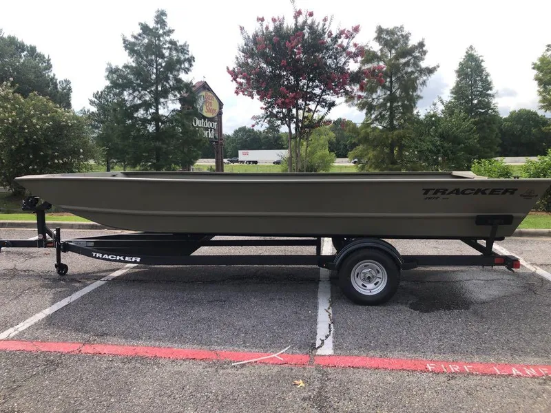 Slide: The Image of 2025 Tracker GRIZZLY 2072 Utility boat on trailer, parked outdoors. - 0