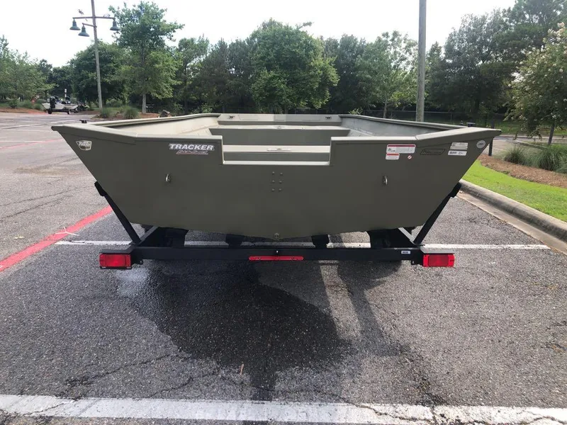 Slide: The Image of 2025 Tracker GRIZZLY 2072 Utility boat on trailer in parking lot. - 2