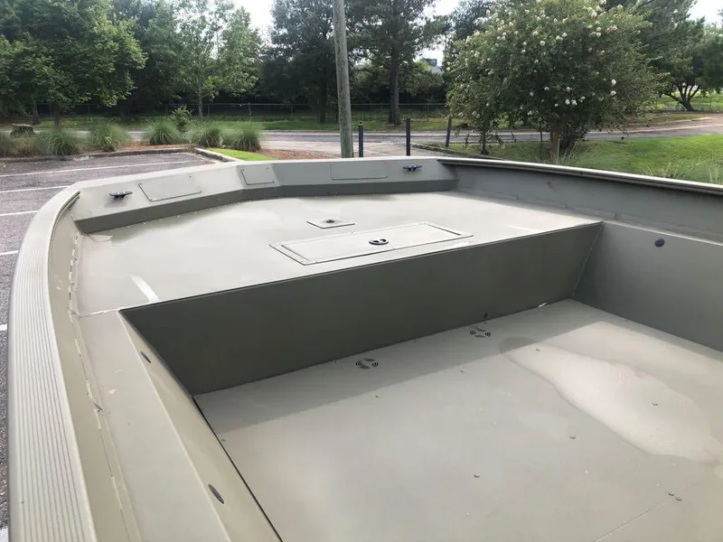 Slide: The Image of 2025 Tracker GRIZZLY 2072 Utility boat interior, spacious deck, parked outdoors. - 8