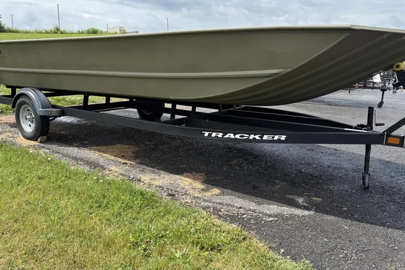 Slide: The Image of 2025 Tracker Grizzly 2072 Utility boat on trailer, parked on asphalt near grass. - 3