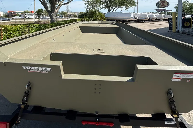 Slide: The Image of 2025 Tracker GRIZZLY 2072 Utility boat, olive green, parked outdoors. - 2