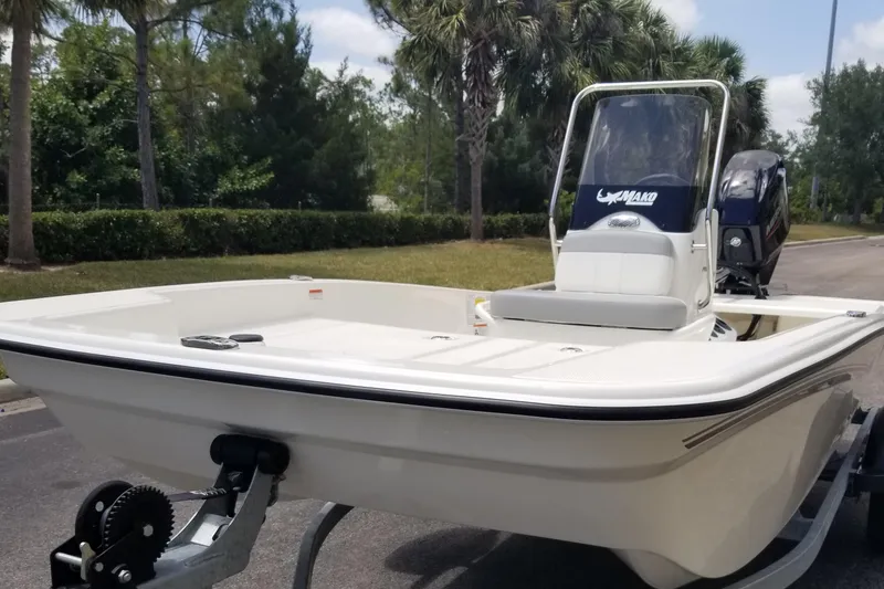 Slide: The Image of 2025 Mako Pro Skiff 15 CC boat on trailer, parked outdoors. - 4