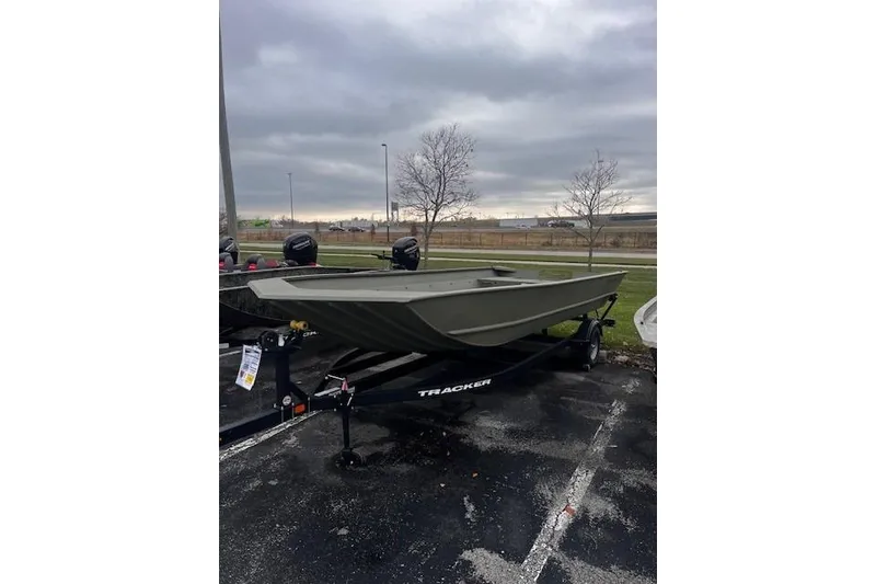 Slide: The Image of 2025 Tracker Grizzly 2072 Utility boat on trailer, parked outdoors under cloudy sky. - 15