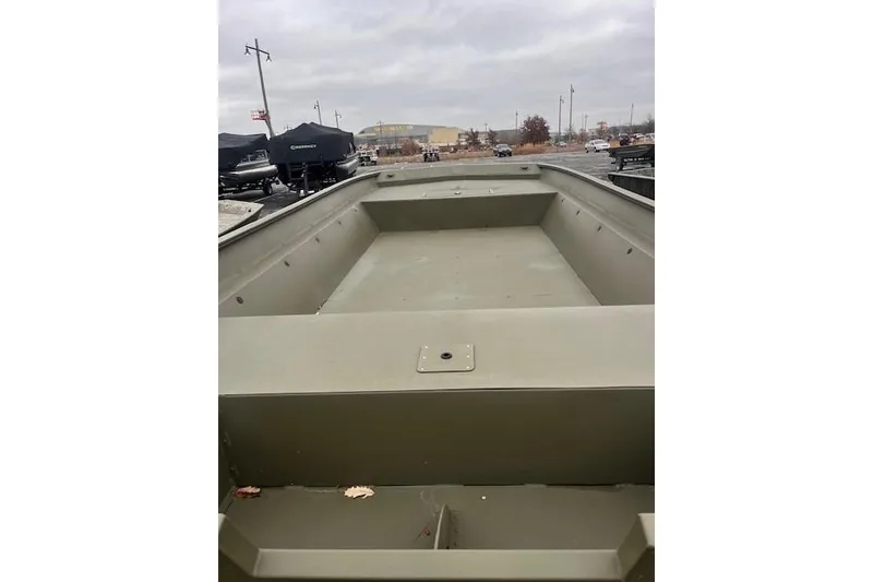 Slide: The Image of 2025 Tracker Grizzly 2072 Utility boat, empty interior view, parked outdoors. - 17