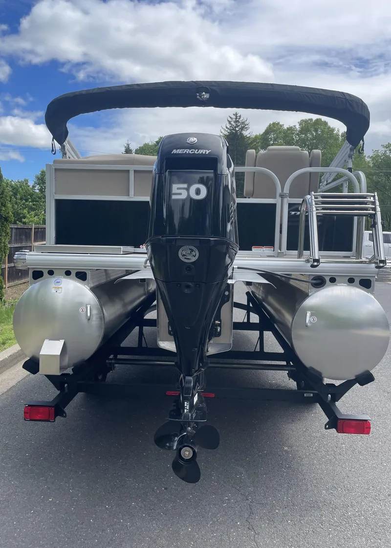 Slide: The Image of 2025 Sun Tracker Party Barge 16 DLX pontoon boat with Mercury 50 engine, rear view. - 5