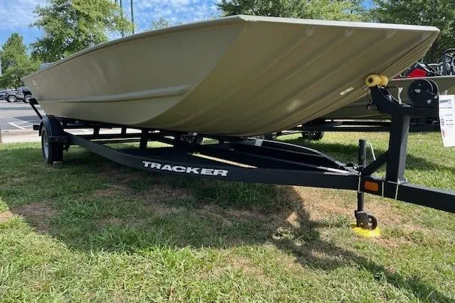 The Image of 2025 Tracker Grizzly 2072 Utility boat on trailer, displayed outdoors on grass. - 0