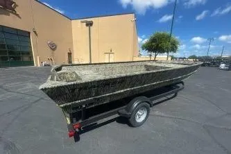 Slide: The Image of 2025 Tracker Grizzly 2072 Utility boat on trailer in parking lot. - 3