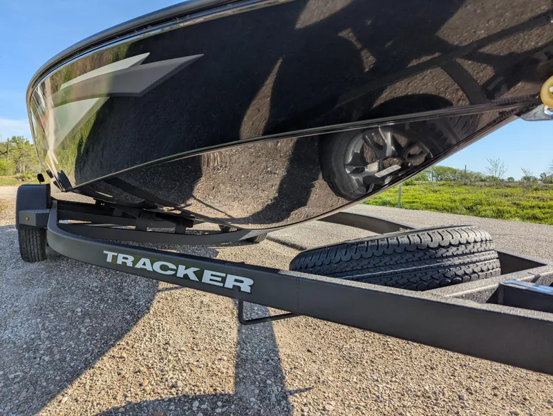 Slide: The Image of 2025 Tracker Savage 215 boat on trailer, close-up view of hull and tire. - 11