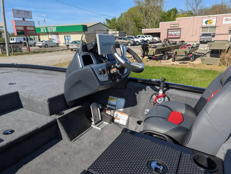 Slide: The Image of Interior of 2025 Tracker Savage 215 boat with Garmin navigation system and comfortable seating. - 13
