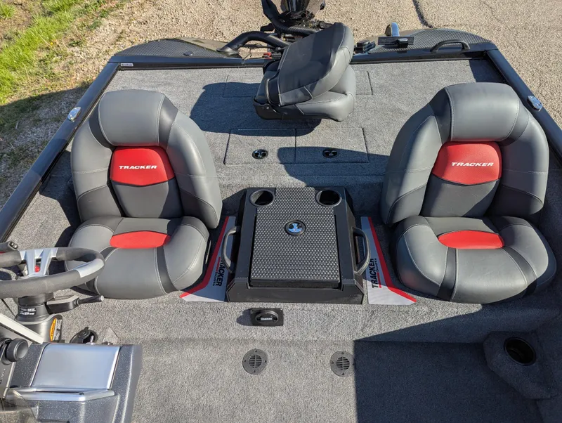 Slide: The Image of 2025 Tracker Savage 215 boat interior with dual gray and red seats, steering wheel, and console. - 14