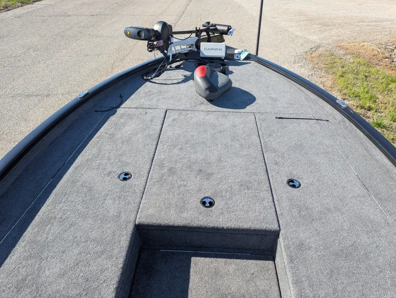 Slide: The Image of 2025 Tracker Savage 215 boat deck with trolling motor and storage compartments. - 15