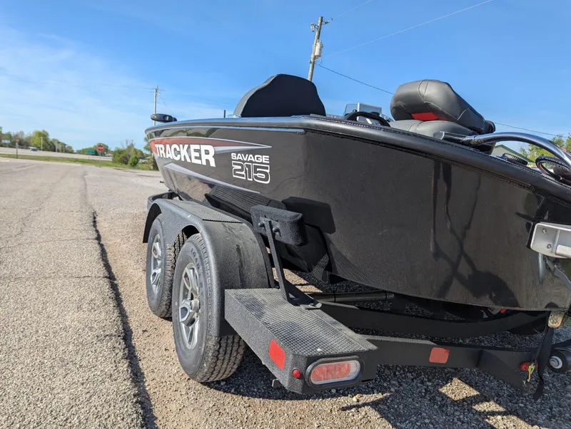 Slide: The Image of 2025 Tracker Savage 215 boat on trailer, parked on a sunny day. - 4