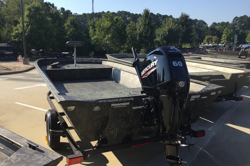 Slide: The Image of 2025 Tracker Grizzly 2072 Utility boat with Mercury 60 engine, parked outdoors. - 4