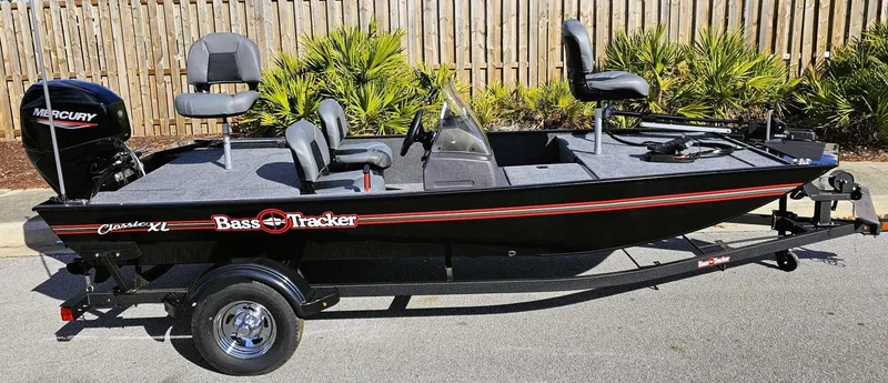 Slide: The Image of 2025 Tracker Bass Tracker Classic XL fishing boat on trailer, featuring Mercury outboard motor. - 3