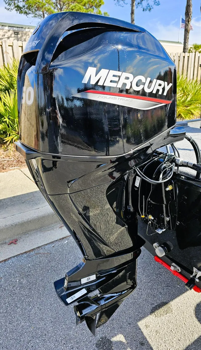 Slide: The Image of 2025 Tracker Bass Tracker Classic XL with Mercury outboard motor, parked outdoors. - 5