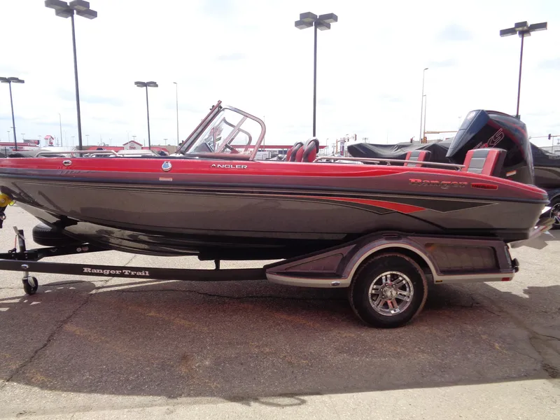 Slide: The Image of 2025 Ranger 1880MS boat with red and black design on a trailer in a parking lot. - 4