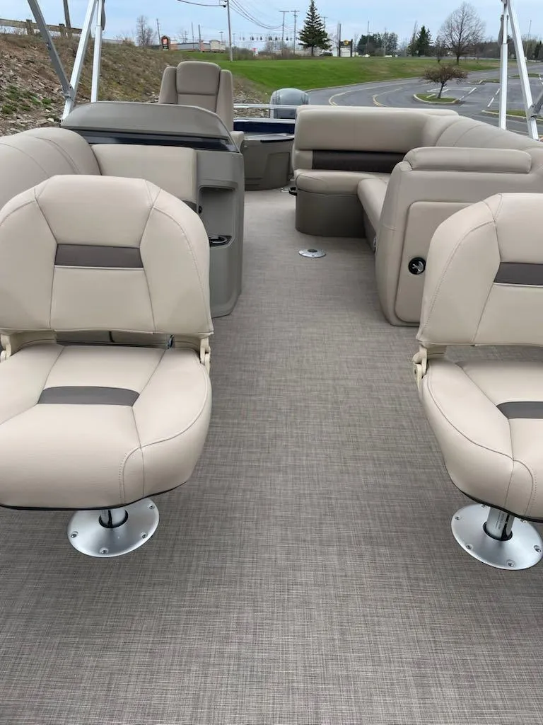 Slide: The Image of 2025 Sun Tracker Fishin' Barge 20 DLX interior with beige seating and spacious layout. - 3