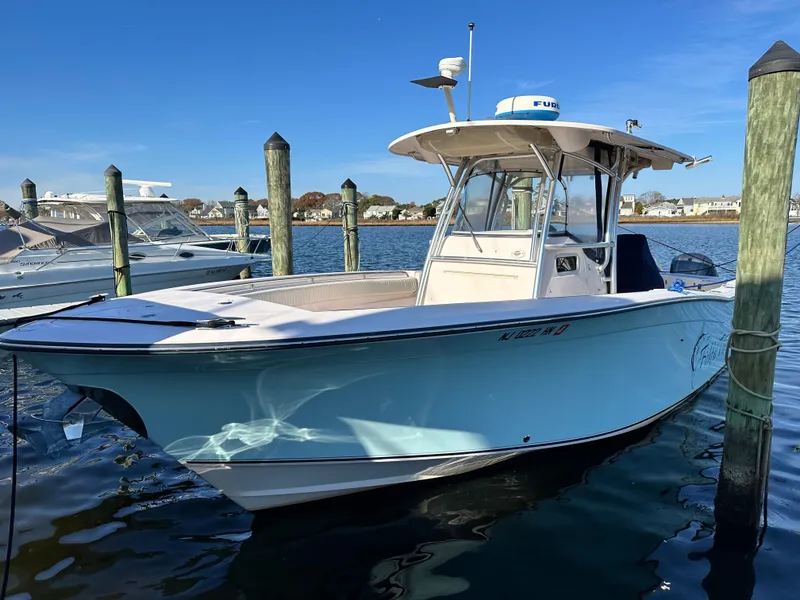 Slide: The Image of 2008 Grady-White Bimini 306 boat docked in a marina under clear blue skies. - 1