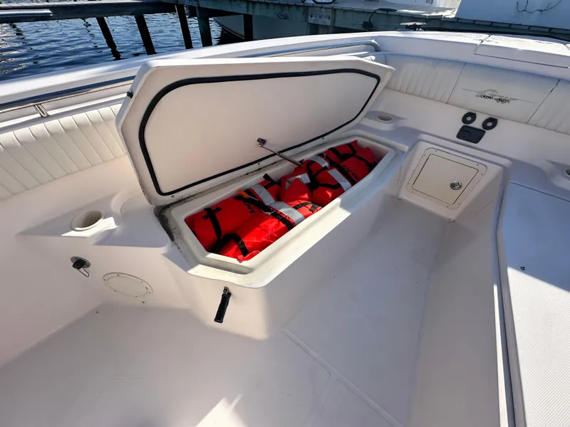 Slide: The Image of Open storage compartment on 2008 Grady-White Bimini 306 boat with life jackets inside. - 12