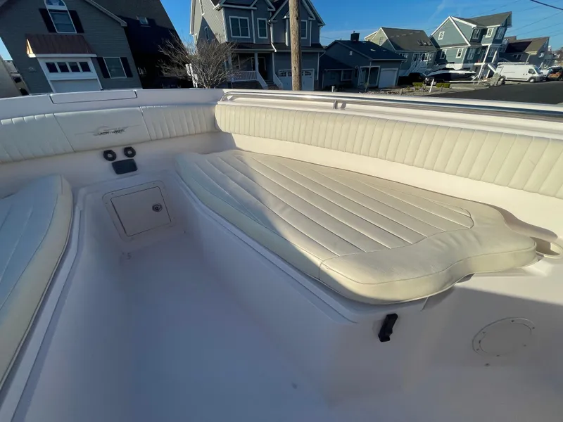 Slide: The Image of 2008 Grady-White Bimini 306 boat interior with cushioned seating in a residential area. - 13