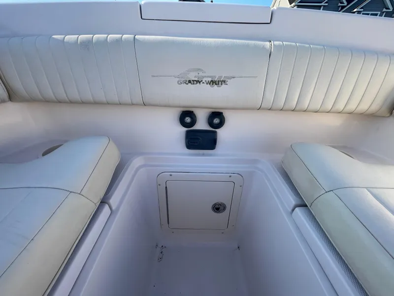 Slide: The Image of 2008 Grady-White Bimini 306 boat interior with cushioned seating and storage compartment. - 14