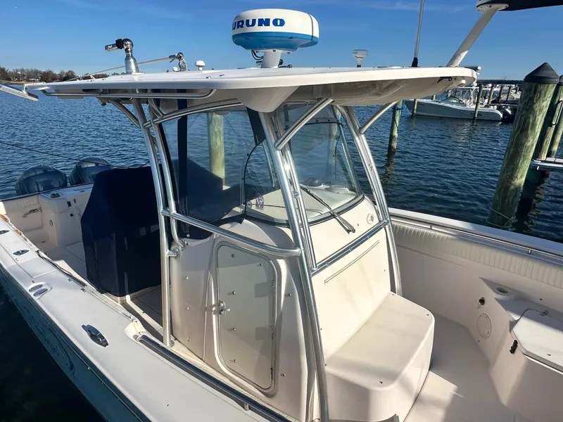 Slide: The Image of 2008 Grady-White Bimini 306 boat docked, featuring a sleek design and spacious seating. - 15