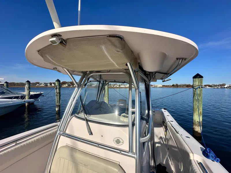 Slide: The Image of 2008 Grady-White Bimini 306 boat docked, featuring a sleek design and spacious deck. - 16